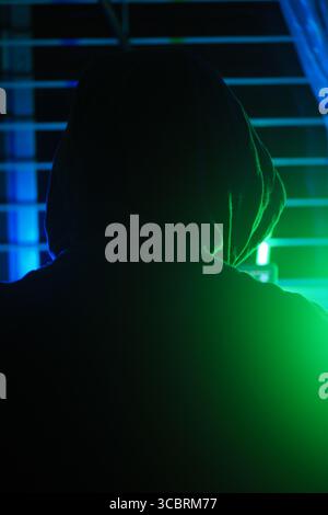 a hacker working in a dark room, cyber crime concept  Stock Photo