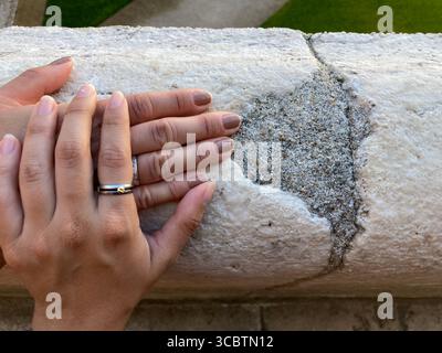 Close up on hands together in wornout balcony Stock Photo