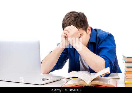 Sad Student with a Books and Laptop Computer on the White Background Stock Photo