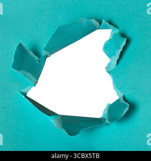 Close up torn blue paper hole background. Hole isolated on white background. Stock Photo