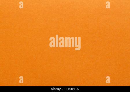 Orange paper sheet fabric texture. Orange canvas cardboard texture as a background. Orange paperboard photographic background. Stock Photo
