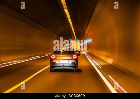 Driving through a tunnel, long exposure, blur, light trails. german autobahn romantic, blurry. on the road in germany, on german autobahn tunnel, warp Stock Photo