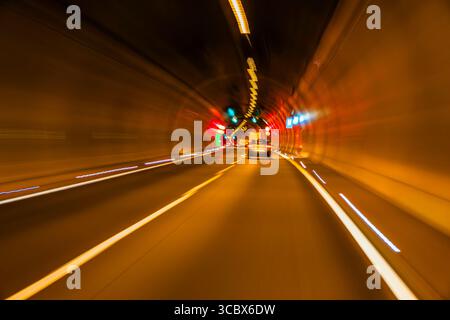 Driving through a tunnel, long exposure, blur, light trails. german autobahn romantic, blurry. on the road in germany, on german autobahn tunnel, warp Stock Photo
