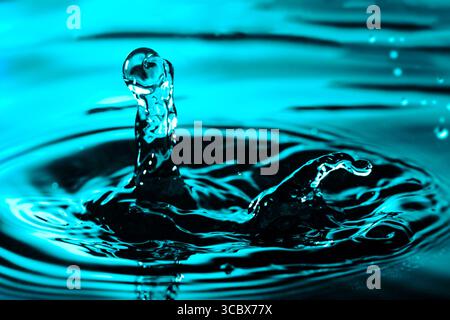 Water drops on blue bright background. Colorful circles water surface with rings and ripples from water drops splash. Ecology concept Stock Photo
