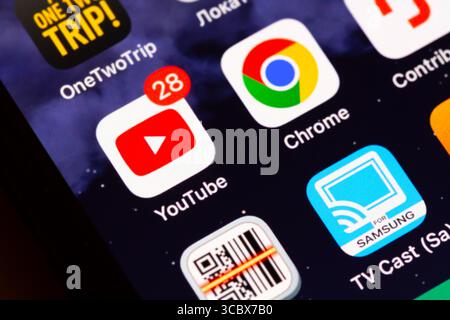 Moscow, Russia - December 13, 2024: YouTube and Google Chrome app icons on display of an iPhone. Stock Photo