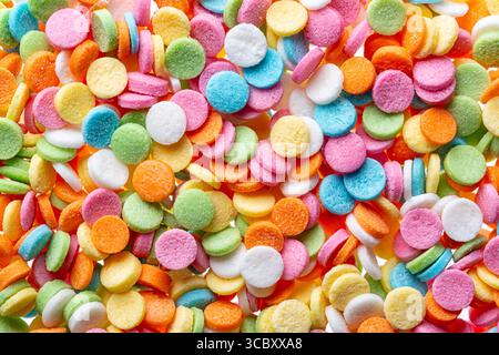 Sprinkle close up background. Colorful round sprinklers. Decoration for cake, donut, bakery. Candy topping background. Stock Photo