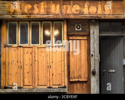 Old stripped pine window and door shutters on house in Brussels, Belgium. Stock Photo