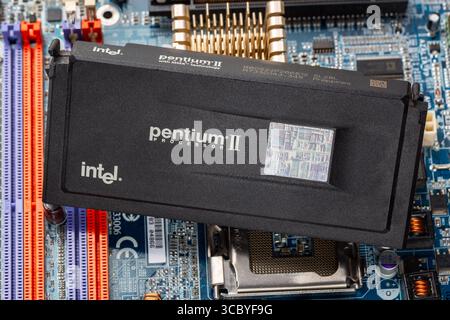 Russia, Moscow - January 11, 2025. Intel Pentium II MMX Slot 1 CPU on a PC Motherboard. Stock Photo