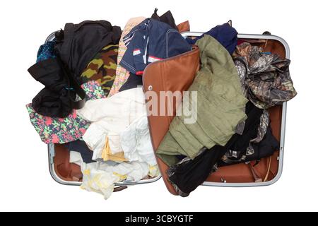 Open suitcase with belongings and clothes isolated on white background. Top view Stock Photo