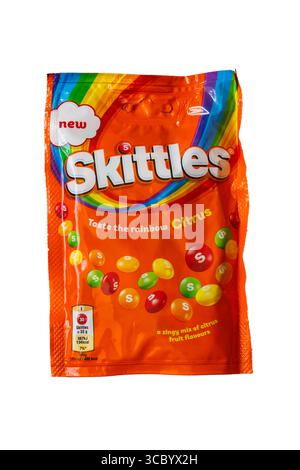 bag of new Skittles Taste the Rainbow Citrus isolated on white background - chewy candies in a crisp sugar shell with citrus fruit flavours Stock Photo