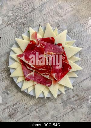 ham and cheese platter on a wooden table Stock Photo