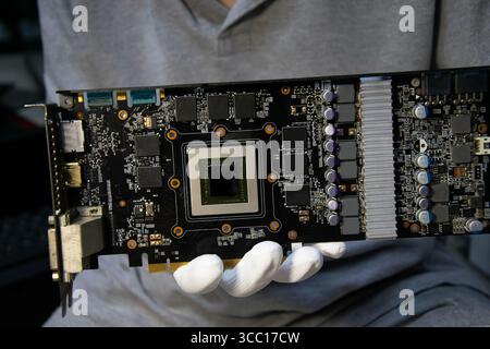 Technician holding a graphics card, computer parts, circuit repair Stock Photo