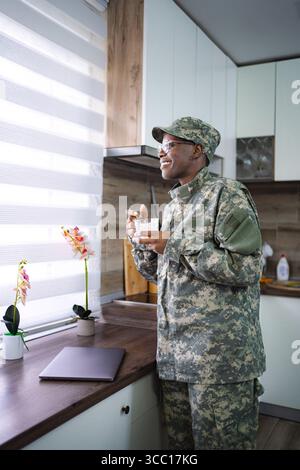 Smiling Soldier Enjoying Breakfast in Kitchen Stock Photo
