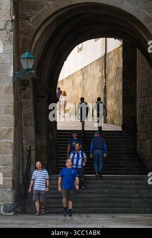 People walking through portal at Obradoiro Square, Santiago de Compostela, A Coruña, Spain Stock Photo