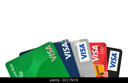 East Gwillimbury, Ontario, Canada - August 5, 2025: An assortment of Visa credit cards of various banks fanned out isolated cutout on white Stock Photo
