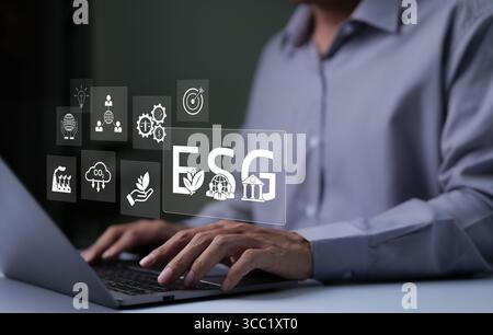 ESG environmental social governance investment business concept. Businessman working with ESG report icons. Analysis of ESG sustainability and corpora Stock Photo