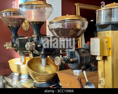 Close-up of vintage coffee grinders in a cafe in Athens, Greece, showcasing the traditional coffee grinding process. Stock Photo