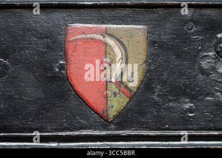 Vintage Shield Emblem Painted on Rustic Black Metal Surface. Salisbury, England Stock Photo