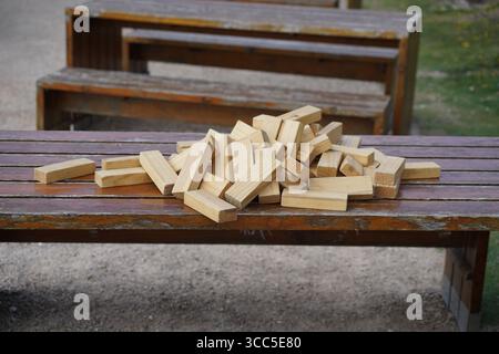 Pile of Wooden Blocks on an Outdoor Picnic Bench. Salisbury, England Stock Photo