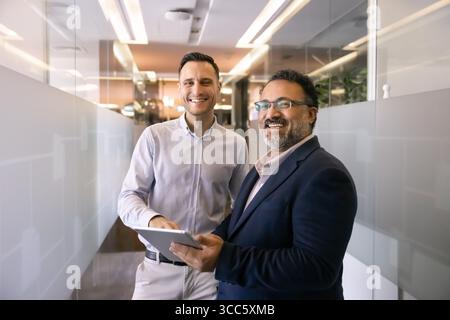 Two happy diverse coworkers posing for professional portrait Stock Photo