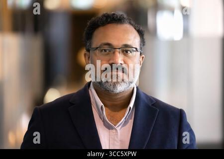 Serious elder Indian businessman looking at camera Stock Photo