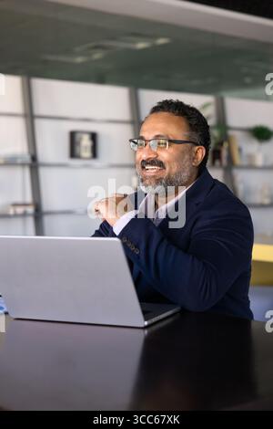 Cheerful elder Indian business product owner thinking on professional success Stock Photo