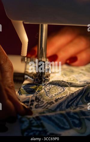 woman sewing by machine, close-up sewing tasks Stock Photo