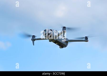 Advanced drone flying on a clear day with camera facing forward for aerial capture Stock Photo