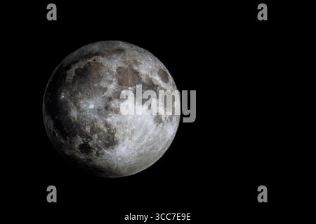 Full Moon with sharp craters and surface detail against black space Stock Photo