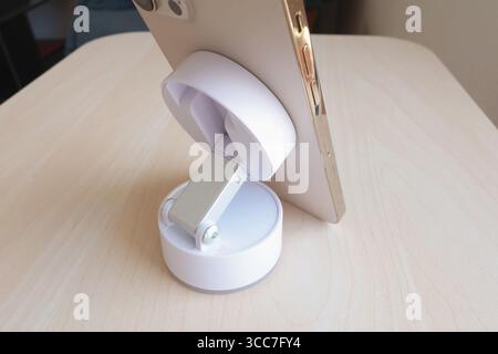 White stand with suction cup and magnet for smartphone. Technology and equipment. Stock Photo