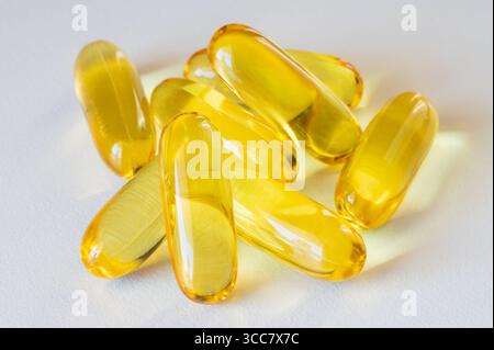 Pile of fish oil supplement gel capsules isolated on white background Stock Photo
