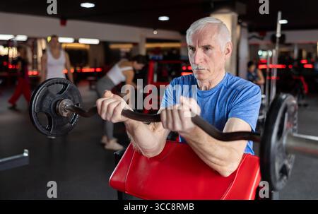Active man during exercises to strengthen muscles of hands and body ...