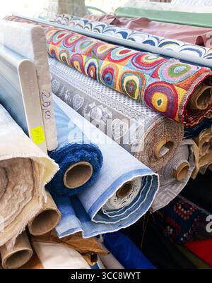 Padova, Italy - April 18, 2025: Colorful fabric samples showcasing various textures and shades, including velvet and cotton, ideal for textile design Stock Photo
