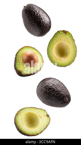 falling avocadoes with slices isolated on white background. Stock Photo