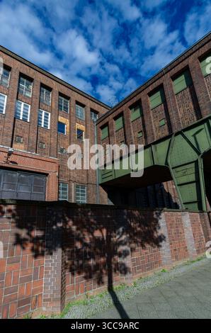 Historic brick architecture of Klingenberg Power Plant in Berlin Rummelsburg with striking tree shadow on the wall. Stock Photo