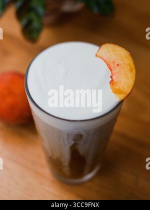 Peach Cold‑Foam Coffee in Tall Glass (close‑up) Stock Photo