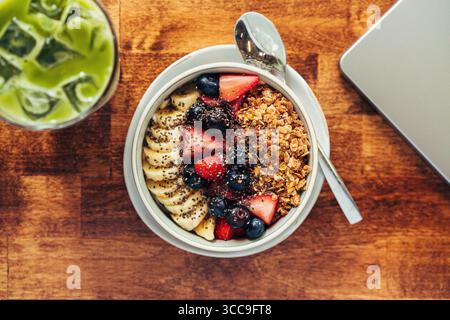 Top-Down Berry–Banana Granola Bowl with Iced Matcha Stock Photo