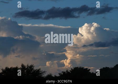 Billowing clouds catch evening light in rural Kanagawa, Japan. Stock Photo