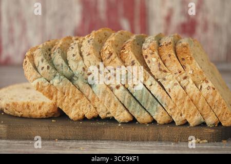Mold bread on wooden board with rustic background Stock Photo