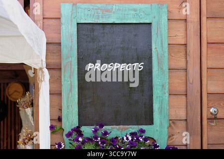 Plans and strategies for marketing marketing personalization concept. PROSPECTS word written on Charming wooden wall with a turquoise-framed chalkboar Stock Photo