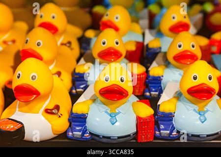 There are many souvenir rubber ducks on the shelf. Stock Photo
