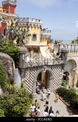 Main ornate entrance gate of Pena Palace with tourists exploring Stock Photo