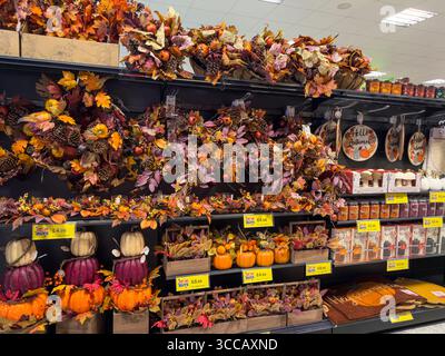 Halloween costumes, decorations, and party supplies on sale in seasonal display at UK department store – spooky October retail merchandising Stock Photo