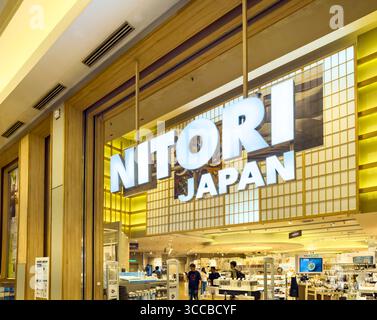 Storefront of Nitori Japan in a shopping mall, featuring modern branding and a glimpse of the interior and customers Stock Photo