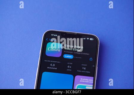 A Smartphone Screen Shows The Canva Logo Against A Blue Background Stock Photo