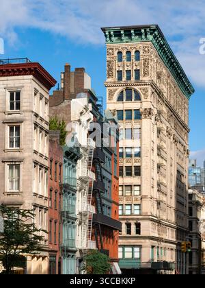 Terra-cotta facades, cornices, and fire escapes of lower Broadway buildings in SoHo. Historic cast-iron architecture in Lower Manhattan, New York City Stock Photo