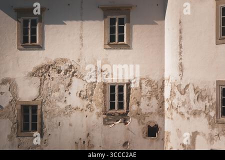 Deeply worn stucco on building in Tavira, Portugal Stock Photo