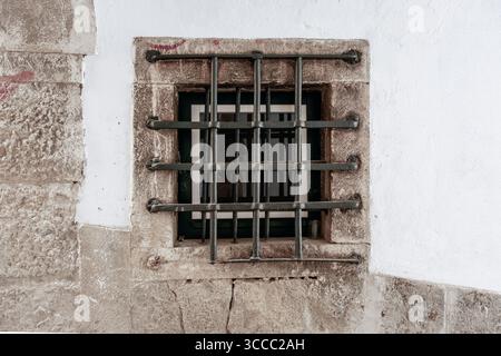 Small barred window in Lisbon, Portugal Stock Photo