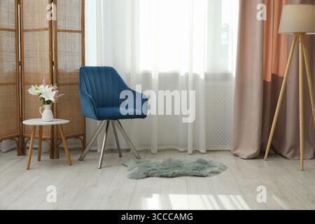 Stylish furniture near window with curtains in living room. Interior design Stock Photo