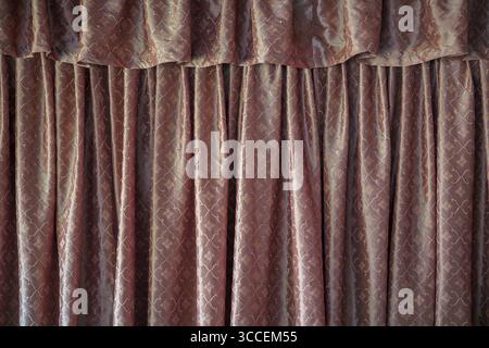 Elegant brown patterned curtains with pleated fabric texture create sophisticated interior backdrop. Rich decorative drapes perfect for home decor, in Stock Photo